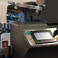 Industrial control panel with touchscreen and joystick. Textile industry machinery. Selective focus.