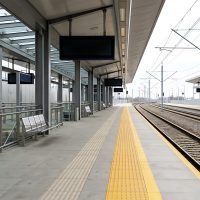 Modern train platform with tracks and digital information displays
