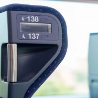 Blue train seats numbers whit bright window close up